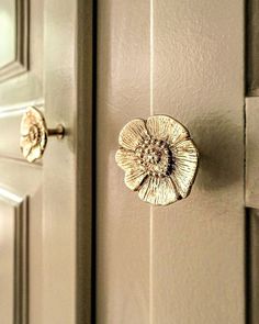 a close up of a door handle with a flower on it