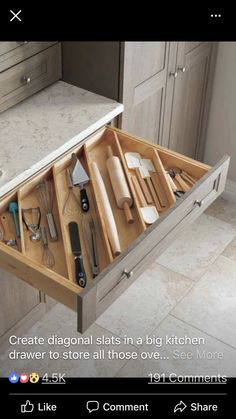 an open drawer with utensils and other kitchen items in it on the counter