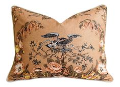 a decorative pillow with two birds on it