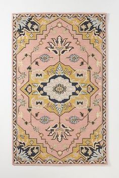 a pink rug with an ornate design on it