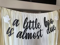 a white curtain with black lettering that says, a little bit almost duee