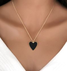 Our black enamel heart pendant on a gold cable chain is a stylish and elegant piece of jewelry.  The heart-shaped pendant is 14k gold plated brass coated on one side with black enamel, a durable material that creates a sleek and glossy surface.  Overall, this combination creates a striking contrast between the bold black heart and the lustrous gold chain, making it a timeless accessory suitable for various occasions. IT'S IN THE DETAILS * 14K Gold Filled Cable Chain * 14K Gold Plated Black Heart Pendant / 24x28mm * 14K Gold Plated Black, Pink or White Heart Pendant / 24x28mm WHY YOU'LL LOVE IT * Because handmade = made with love, care, and thought. * Ethically Sourced * Comes beautifully gift boxed * Crafted with care from sunny South Florida. HAPPINESS GUARANTEE: We stand by our jewelry a Chain Making, Handmade Valentine, Gold Heart Necklace, Valentines Day Gifts For Her, Necklace Black, Timeless Accessories, White Heart, Keep Jewelry, Bold Black