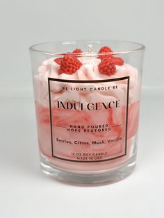 a candle that is inside of a glass container with some fruit on top of it