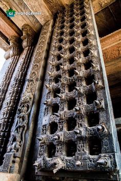 an intricately carved door in the middle of a building