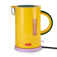 a yellow electric kettle sitting on top of a table