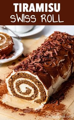 a roll with chocolate sprinkles on it sitting on top of a cutting board