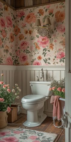 a white toilet sitting in a bathroom next to a flower filled wallpapered wall