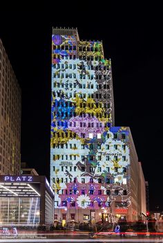 a tall building with lots of windows on it's side at night in the city