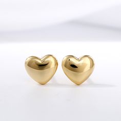 The perfect anytime surprise, these whimsical heart-shaped fashion stud earrings lend a touch of shine to her attire. Crafted in sterling silver, each dainty puffed heart gleams with anytime appeal. So sweet and charming, these heart stud earrings are sure to become an instant favorite.Weight: 1.16 gWidth: 6.6 mmHeight: 5.8 mmThickness: 2.2 mmMaterial: 925 SilverPlating Color: Yellow Gold Luxury Yellow Gold Heart Earrings With Cubic Zirconia, Heart Shaped Gold Earrings, Heart Earings Piercings, Affordable Vintage Heart-shaped Jewelry, Heart Shape Earrings Gold, Heart-shaped Clip-on Earrings For Valentine's Day, Heart Earrings Gold, Heart Gold Earrings, Elegant Heart-shaped Clip-on Earrings For Valentine's Day