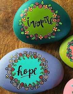 three painted rocks with the words inspire and hope on them