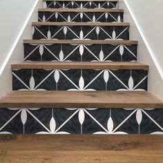 the stairs are decorated with black and white tiles