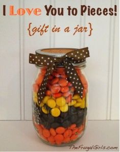 a jar filled with lots of candy sitting on top of a white table next to a door