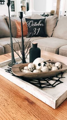 a tray with skulls on it sitting on top of a table next to a couch