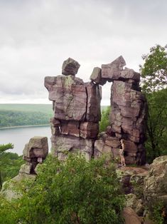 a person standing on top of a large rock formation