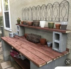 an outdoor shelf with potted plants on it