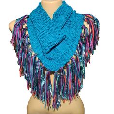 a blue scarf with fringes on top of a mannequin head