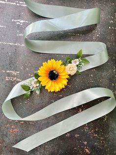 two ribbons with flowers on them sitting next to each other