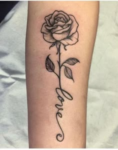 a black and white rose with the word love written in cursive writing on it