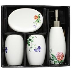 a set of four soap dispensers in a black box with flowers painted on them