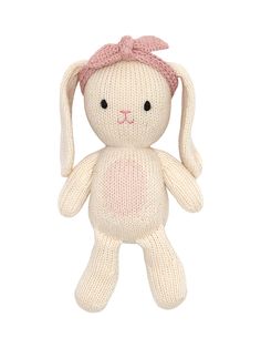 a white knitted stuffed animal with a pink bow on it's head and ears