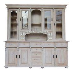 an old wooden china cabinet with glass doors and drawers on the front, in white background