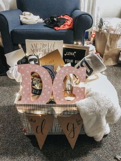 a teddy bear sitting on top of a wooden crate filled with books and other items