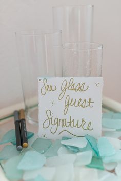 two glasses sitting on top of a table with confetti in front of them