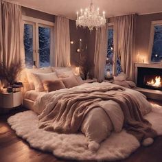 a bedroom with a large bed covered in blankets and pillows next to a fire place