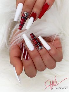 two hands with red and white manies holding candy canes