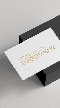 a black and white business card with gold foil lettering on it that says style entertainment