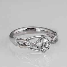 a white gold ring with a diamond in the center