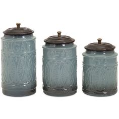 three blue glass jars with brown lids