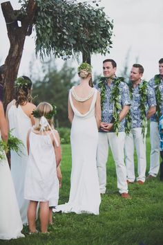 a group of people standing next to each other under a tree