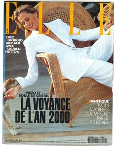 a woman sitting in a wicker chair on the cover of a magazine with her dog