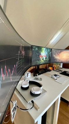 two computer monitors sitting on top of a desk