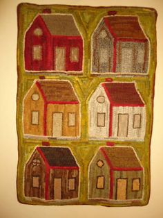 an embroidered wall hanging with houses on it