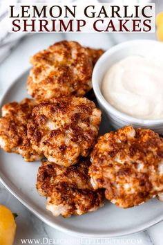 lemon garlic shrimp cakes on a white plate with a small bowl of ranch dressing in the background