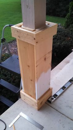 a wooden post sitting on top of a sidewalk