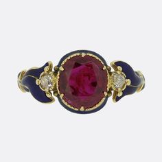 Here we have a delightful ruby and diamond ring from the Victorian era. A stunning round faceted Burmese ruby possessing a vibrant medium colour tone sis at the centre of the face and is flanked on either side by a single old mine cut diamond. These focal stones are then complimented by a pair of beautifully crafted shoulders; each of which has been expertly enamelled in a rich navy blue. Condition: Used (Very Good) Weight: 3.4 grams Ring Size: P (57) Ruby Weight: 2.48ct (this ruby has been treated to intensify its colour) Total Diamond Weight: Approx. 0.20ct (0.10 each) Tested As: 15ct Gold Period: Victorian Box: The Vintage Jeweller Ring Box Luxury Victorian Enamel Ring, Luxury Victorian Ruby Cabochon Ring, Vintage Cluster Engagement Rings, Burmese Ruby Jewelry Indian, Victorian Ruby Ring, Vampire Engagement Ring, Ruby Vintage Ring, Victorian Rings Engagement, Victorian Jewellery