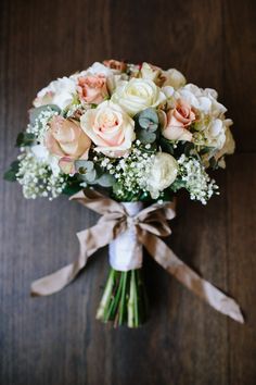 a bouquet of flowers tied to a wooden table