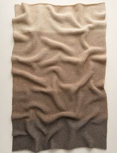 an image of a knitted blanket with different colors and textures on the bottom half