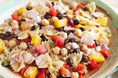 a bowl filled with pasta salad on top of a table