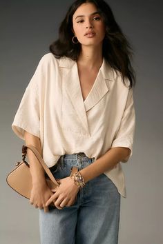 The Dylon Short-Sleeve Wide-Placket Top | Anthropologie Modern V-neck Top For Spring, Effortless V-neck Blouse For Day Out, Trendy Oversized V-neck Blouse, Modern V-neck Blouse For Fall, Modern V-neck Tops For Summer, Summer Beige Top With Lapel Collar, Spring Relaxed Fit V-neck Top For Day Out, Chic Spring Blouse With Notched Neckline, Spring V-neck Top For Day Out With Relaxed Fit