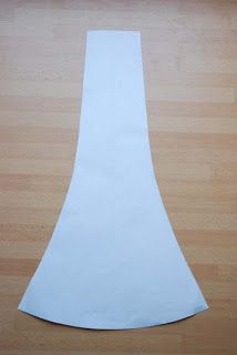 a piece of white paper sitting on top of a wooden floor