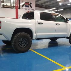 a white truck is parked in a garage