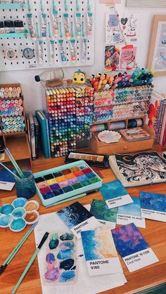 art supplies are sitting on a wooden table