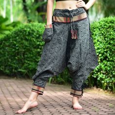 "Black Thai Traditional pattern pants, Hmong pants, Traditional Thai pants, Harem pants, Unisex pants Tribal pants is very comfortable and easy to wear, Unisex for Men and Women Every Detail of Tribal pants is made by Thai Craftsmanship. Tribal pants is inspired by Tribal in the North of Thailand or Hmong. Redesign for easy to wear and comfy. Great for many occasion activities like Chilling time, Casual wear, Relax time. This item is made of high-quality cotton in the north of Thailand. Printed Black Bohemian Ankle-length Pants, Traditional Trousers For Festival, Traditional Festival Trousers, Black Harem Pants For Festival, Bohemian Black Festival Pants, Black Bohemian Harem Pants Ankle-length, Black Harem Pants With Pockets For Festival, Black Bohemian Ankle-length Harem Pants, Traditional Baggy Ankle-length Bottoms