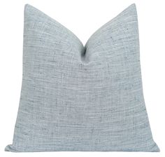 a light blue pillow on a white background