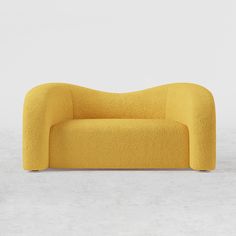 a yellow couch sitting on top of a cement floor