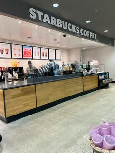 a starbucks coffee shop with purple cups on the counter